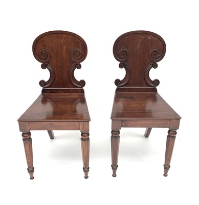 Lot 3206 - A pair of late George III mahogany hall chairs,...