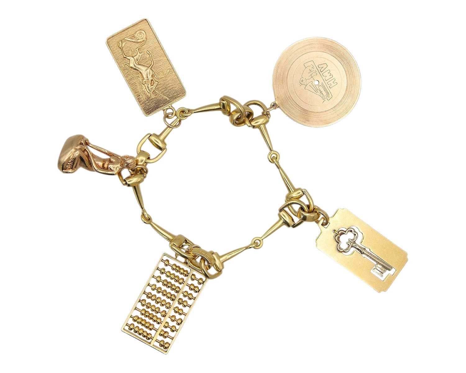 Lot An 18k hallmarked gold horse bit bracelet, applied with five gold charms.