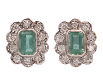 Lot 107 - A pair of emerald and diamond cluster earrings, set in 9k yellow and white gold.