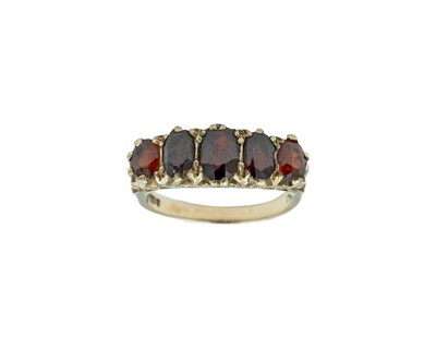 Lot 56 - A 9k oval garnet set five-stone ring, in Edwardian style.