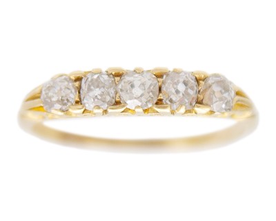 Lot 28 - A Victorian gold old mine-cut diamond-set five-stone ring.