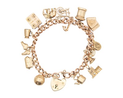 Lot 29 - A rose-gold curb-link charm bracelet, set with yellow metal and 9k hallmarked charms.