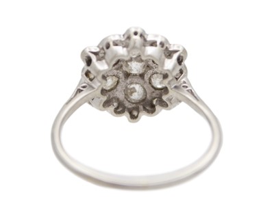 Lot 34 - An early 20th-century old mine-cut diamond cluster ring, set in white metal.