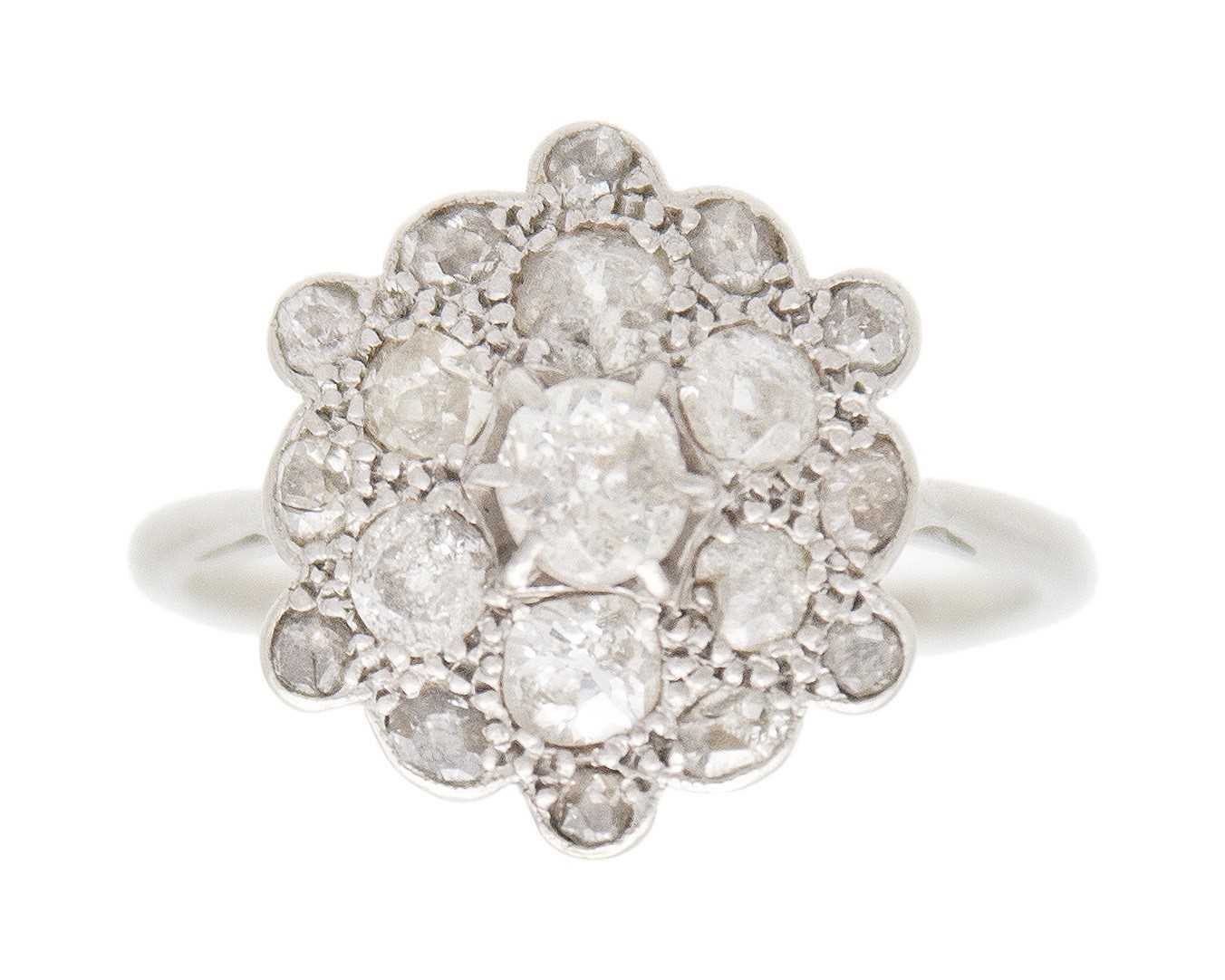 Lot 34 - An early 20th-century old mine-cut diamond cluster ring, set in white metal.