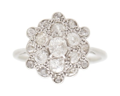 Lot 34 - An early 20th-century old mine-cut diamond cluster ring, set in white metal.