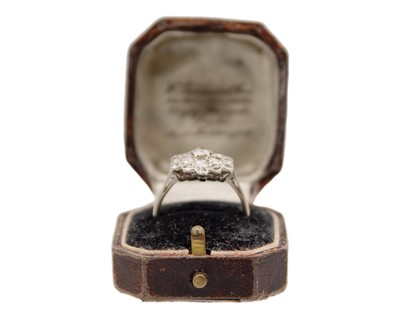 Lot 34 - An early 20th-century old mine-cut diamond cluster ring, set in white metal.