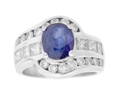 Lot 113 - A good 18k heavy white gold diamond and oval sapphire set dress ring.
