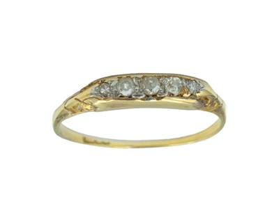 Lot 85 - An early 20th-century gold-and-diamond set five-stone ring.