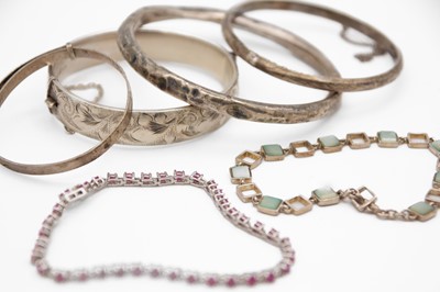 Lot 220 - A selection of silver bangles and gemset bracelets.