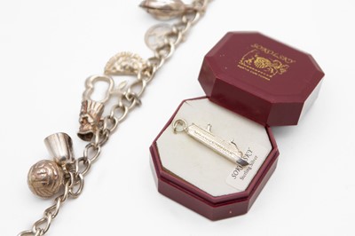 Lot 231 - A silver curb-link charm bracelet applied with numerous silver & white metal charms.