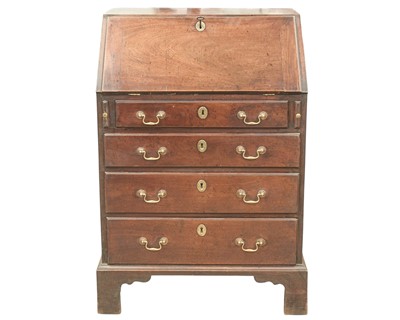 Lot 860 - A George III mahogany narrow drop front writing desk.