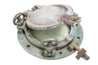Lot 497 - A phosphor bronze porthole with an alloy storm window.