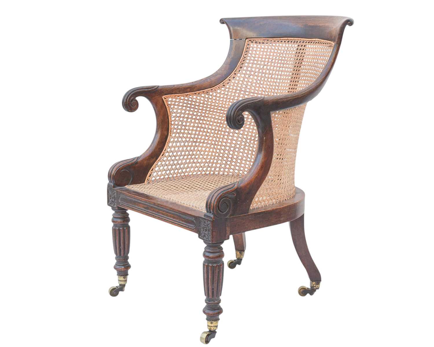 Lot 935 - A Regency rosewood bergere library armchair.