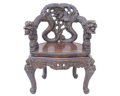 Lot 523 - An ornate Chinese export heavily carved and lacquered dragon open armchair.