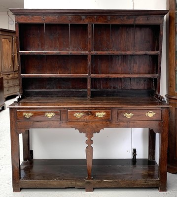 Lot 3177 - A George III oak dresser, the plate rack with...
