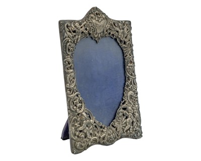 Lot 55 - An ornate Victorian silver picture frame by William Comyns & Sons.