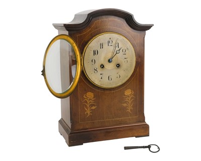 Lot 742 - An Edwardian mahogany and inlaid mantel clock.