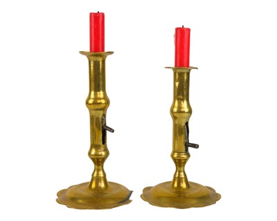 Lot 829 - A pair of 18th century brass petal base candlesticks.