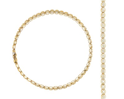 Lot 116 - A 9k yellow and white gold diamond set tennis bracelet.