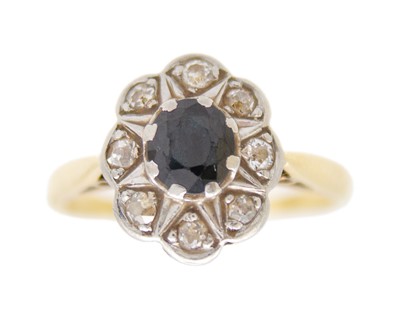 Lot 147 - A diamond and sapphire set cluster ring, set in yellow gold and white metal.