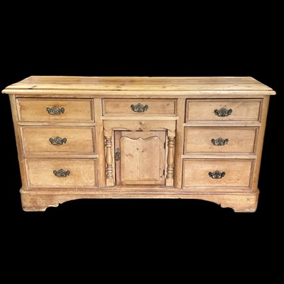 Lot 25 - A Victorian pine dresser base with seven...