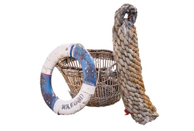 Lot 110 - A wicker fishing basket, a rope fender and a life ring.