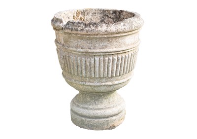 Lot 766 - A composition stone garden urn with fluted decoration.