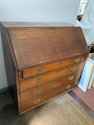 Lot 3193 - An early 19th century oak bureau, with fitted...
