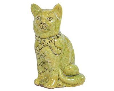 Lot 728 - A green glazed Ewenny cat.