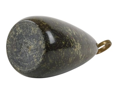 Lot 18 - A Cornish red serpentine doorstop with brass loop handle.