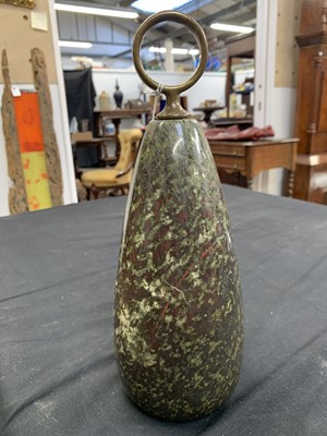 Lot 18 - A Cornish red serpentine doorstop with brass loop handle.