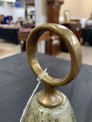 Lot 18 - A Cornish red serpentine doorstop with brass loop handle.