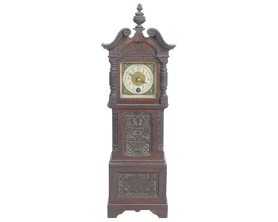 Lot 746 - A late Victorian carved oak miniature longcase clock.