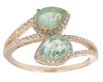 Lot 183 - A 9k yellow gold 1.40ct pear-cut emerald and diamond set crossover ring.