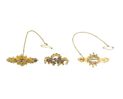 Lot 145 - A selection of three early 20th-century 9k gold brooches.
