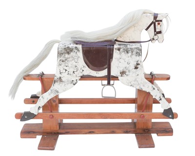 Lot 264 - A carved wooden rocking horse of small proportions.