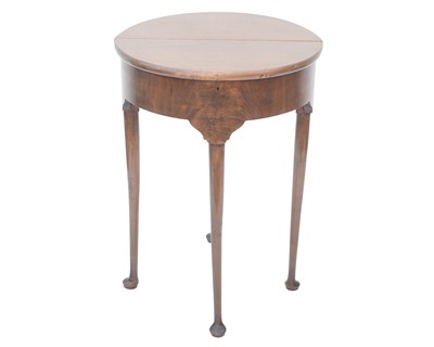 Lot 904 - A George II style mahogany fold top half round tea table.