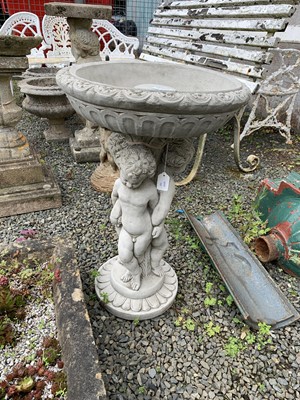Lot 125 - A concrete birdbath with triple cherub...