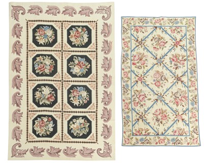 Lot 573 - Two floral needlepoint wool rugs.