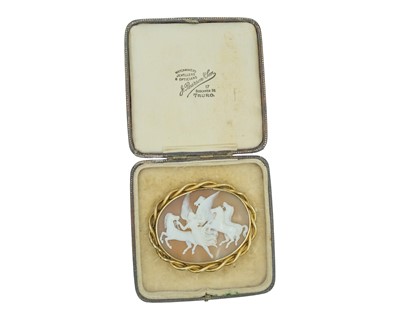 Lot 178 - A 19th-century gold-mounted shell cameo brooch, depicting 'hours leading the horses'.