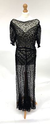 Lot 2860 - An elegant, long 1930’s black lace dress with...