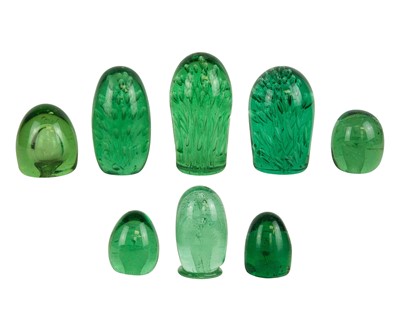 Lot 810 - A collection of eight Victorian green glass dump weights or doorstops.