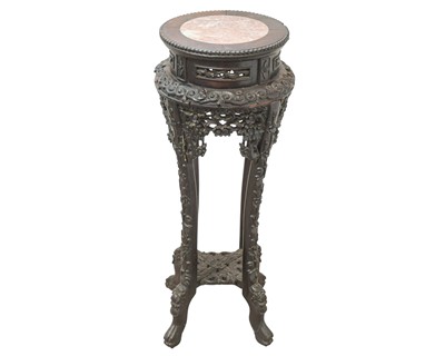 Lot 528 - A Chinese carved hardwood jardiniere stand.