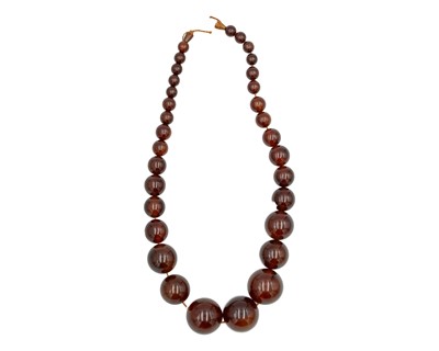 Lot 195 - A cognac amber-style graduated ovoid bead necklace.