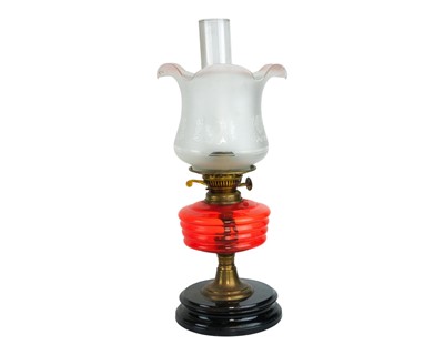 Lot 35 - A Victorian cranberry glass oil lamp.