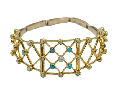 Lot 164 - A Victorian gold cabochon turquoise and pearl set openwork bracelet.