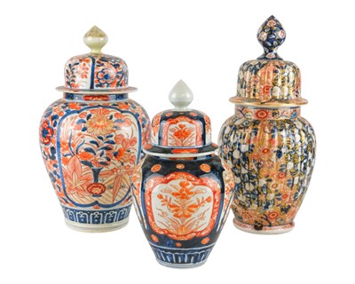 Lot 543 - Three Japanese Imari vases and covers.