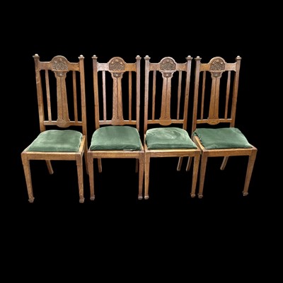 Lot 64 - Four carved oak Arts & Crafts dining chairs.