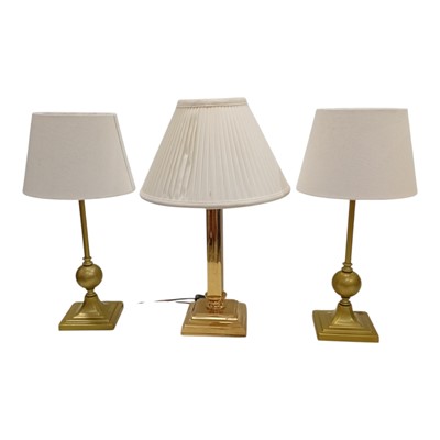 Lot 72 - Three gilt-finish table lamps. 48cm High.