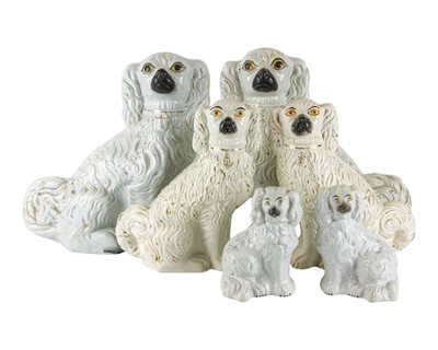 Lot 691 - A pair of late Victorian Staffordshire pottery figures of spaniels.
